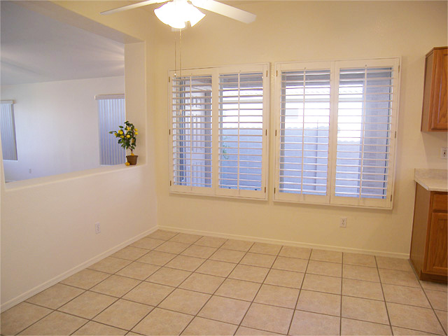 Tiled dining room and kitchen with wooden plantation shutters